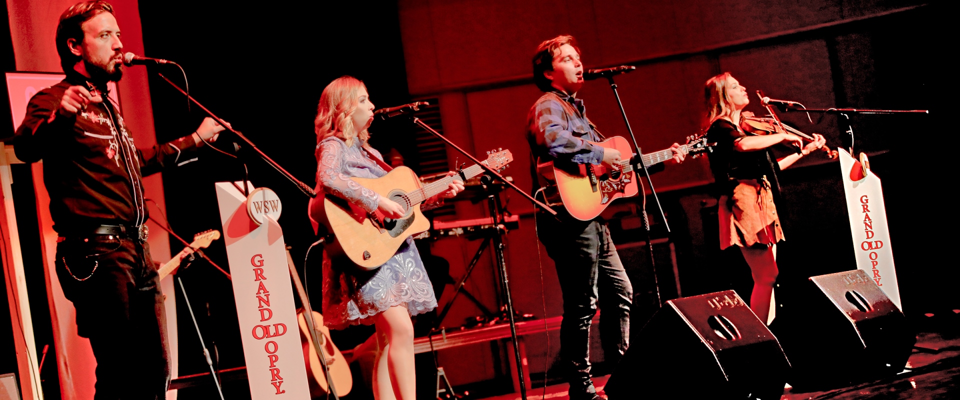Musiker mit Country Kleidung auf einer Bühne.