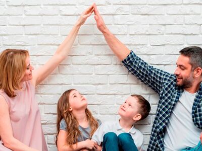 Mein Zuhause, Immobilienmesse, Forum, Altötting, Bild Pixabay Eine Familie mit zwei kleinen Kindern sitzt vor einer weißen Wand.