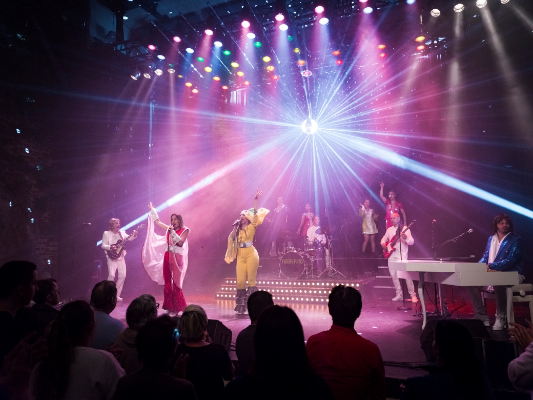 Sänger und Tänzer der Show Abba auf der Bühne. 