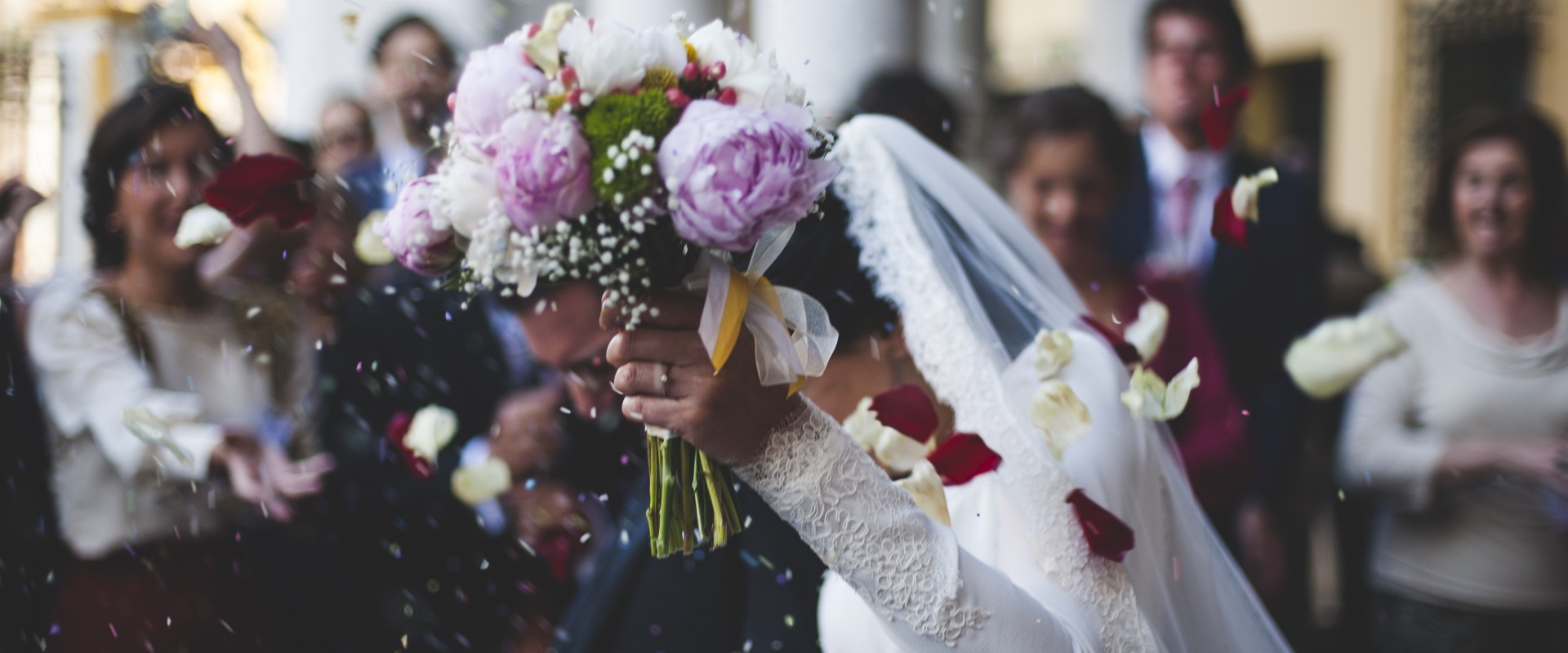 Die Braut mit Ihrem Brautstrauß im Vordergrund bei einer Hochzeit im Altöttinger Forum.